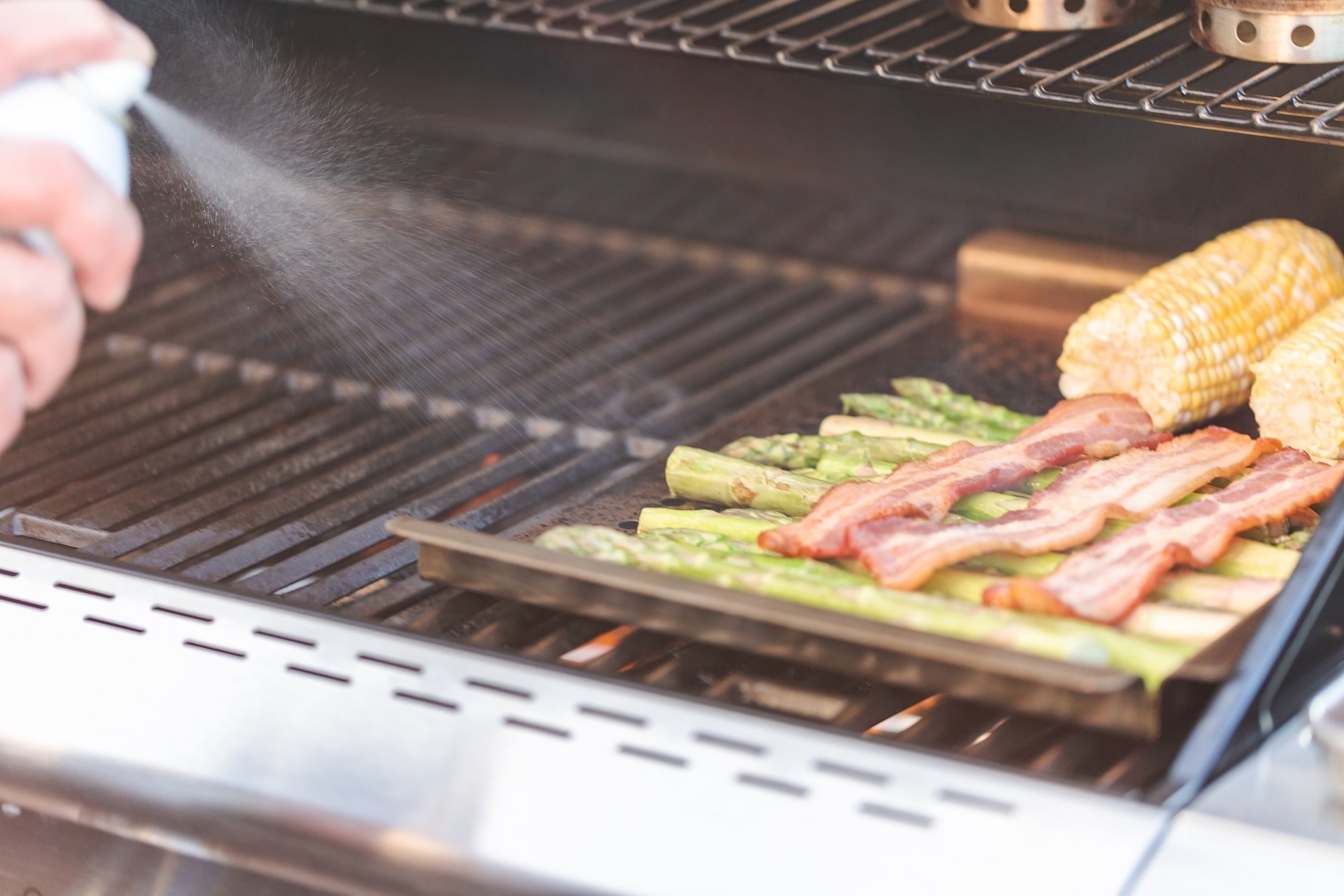 Why You Should Start Keeping A Spray Bottle Next To Your Charcoal Grill