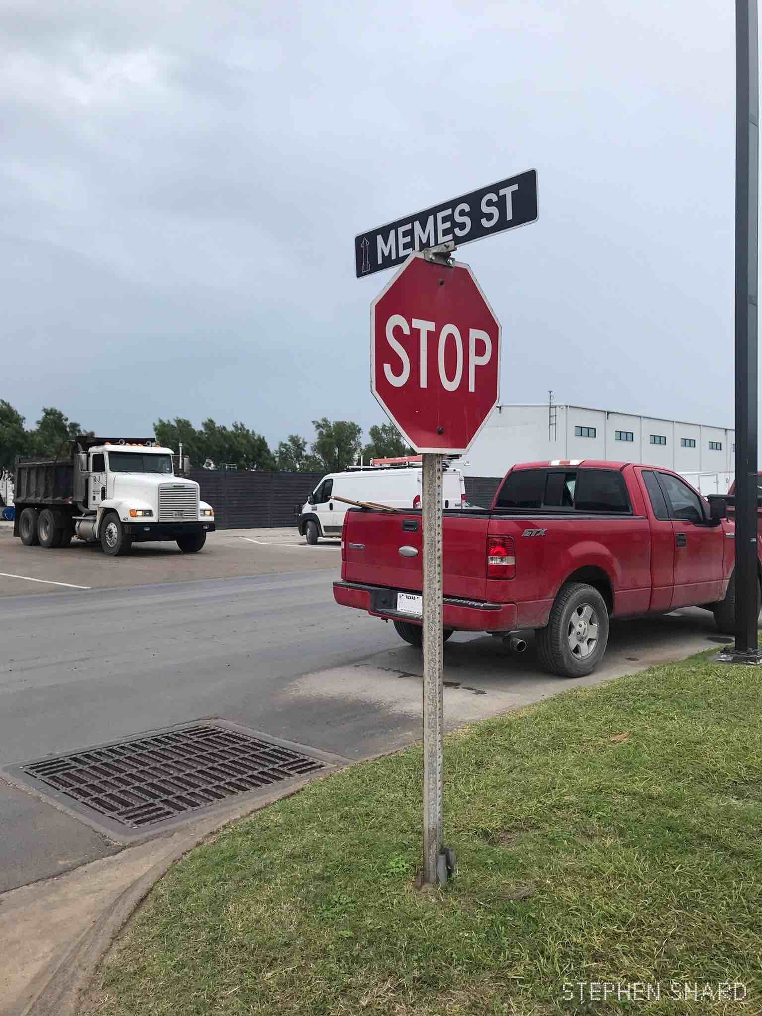 A photo of a stop sign at Starbase Texas with a road marker of "Memes Street" above it.