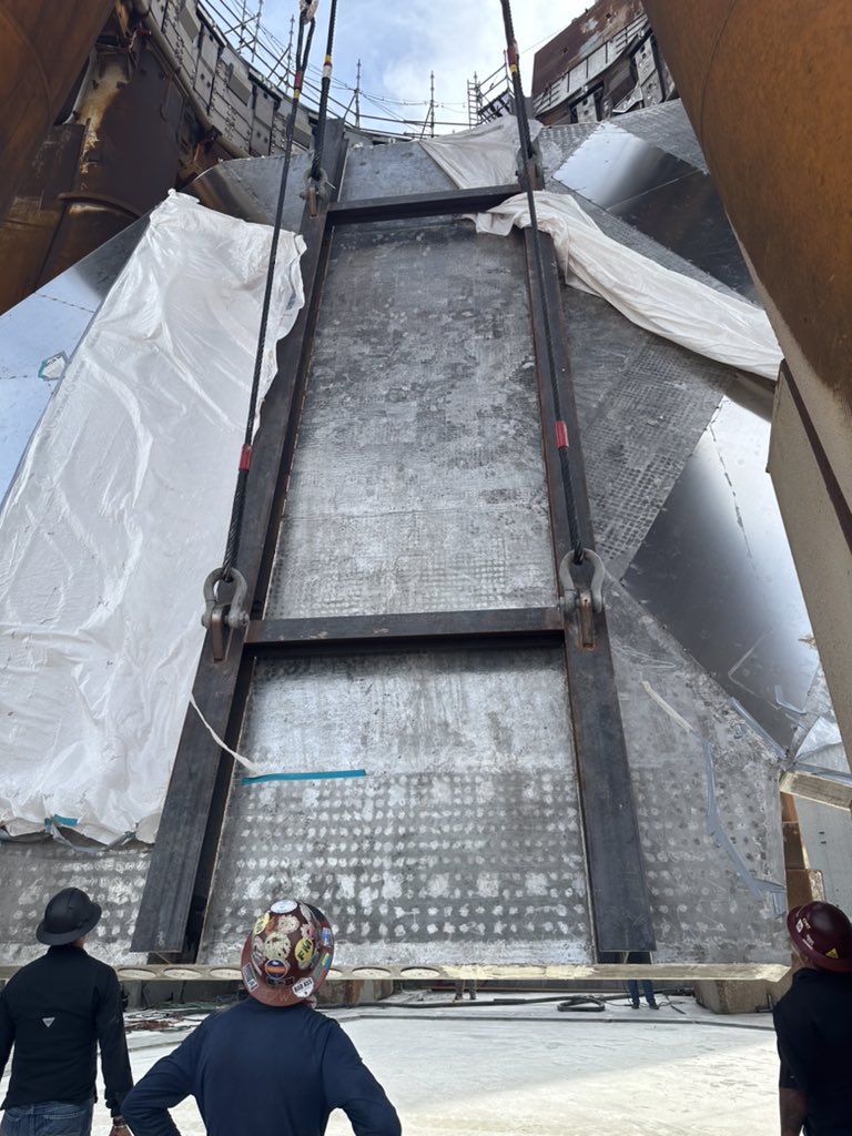 SpaceX engineers oversee the installation of the water-cooled steel plate on the Launch Tower at Starbase Texas.