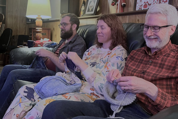 Christmas knitting. From left to right: my brother Mike, me, and my husband Dan.