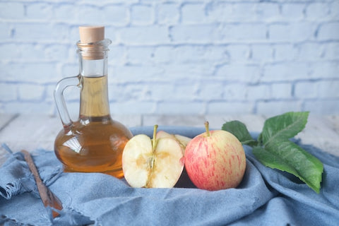 apple cider vinegar bottle with apples