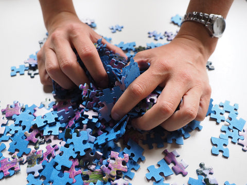 hands holding some puzzle pieces