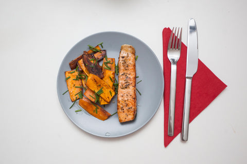 Plate of oven baked salmon and mashed sweet potato for a healthy post workout dinner