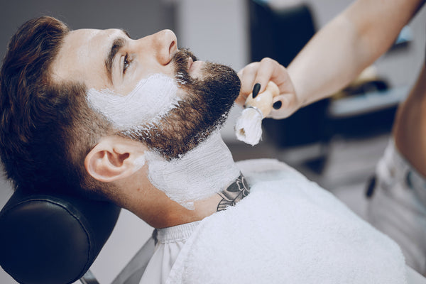 man having his beard groomed