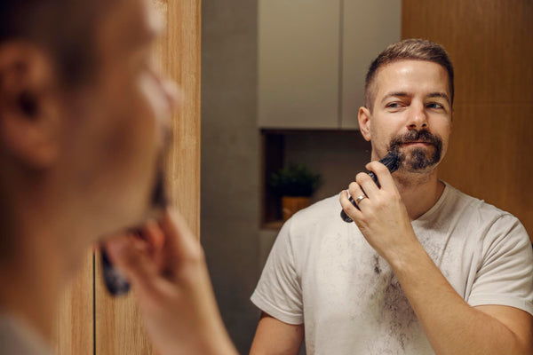 man trimming his beard