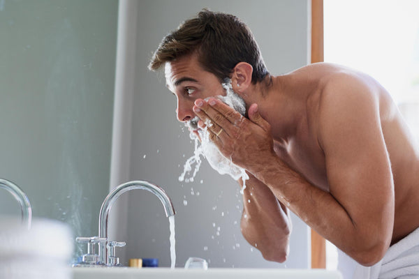 man washing his beard using beard shampoo