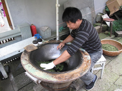 Firing longjing leaves
