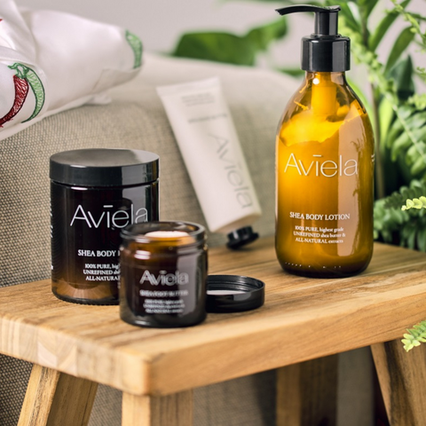 Image of Aviela skincare on a bedside table with pyjamas on the bed