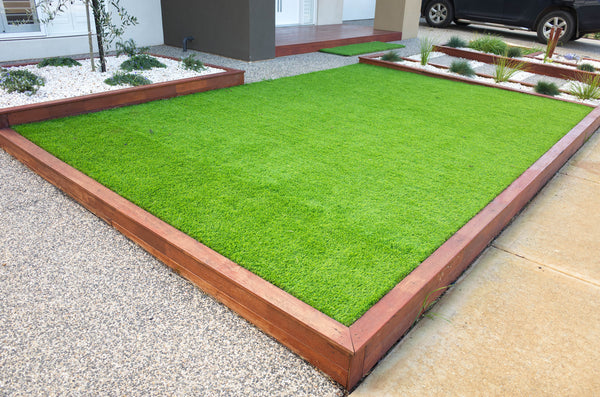 artificial grasslawn turf in the front yard of a modern homeresidential house