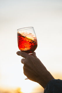 Red wine being swirled in a glass.