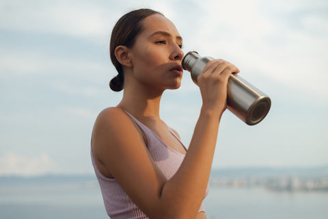 active girl drinking from bottle 