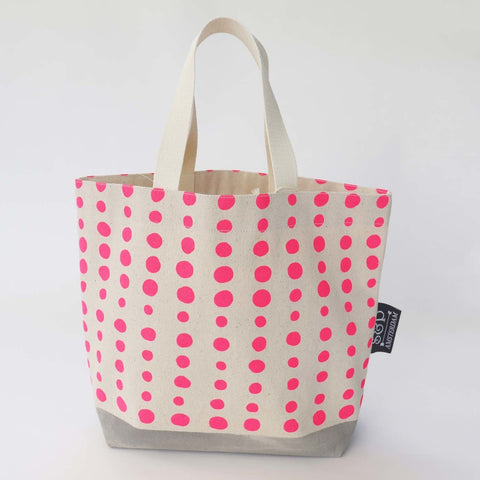 A cream linen bag with pink spots