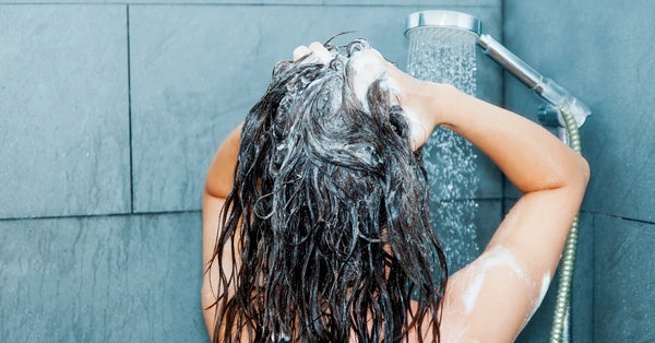 woman washing hair with warm water