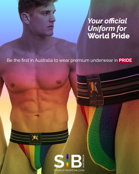 A man with pecs and muscles with a rainbow jockstrap next to a closeup of a torso and groin with rainbow underwear.  Words that says Your Official Uniform for WorldPride