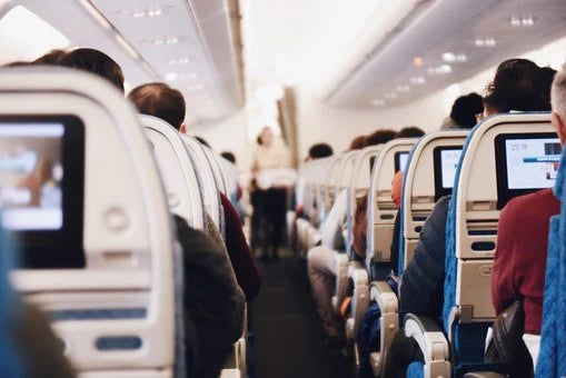 An air plane cabin full of passengers 