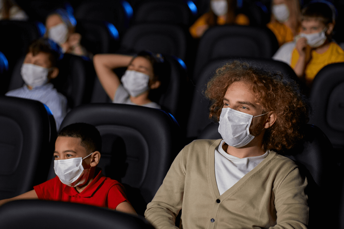 people watching movie with a disposable mask