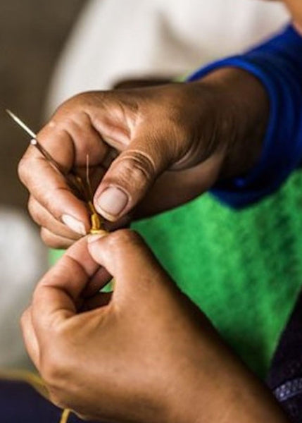 Detailed shot of artisan hands with knitting needles