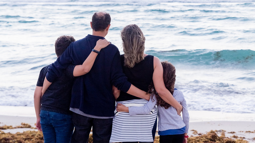 A-family-of-four-snuggled-together-watching-the-sea
