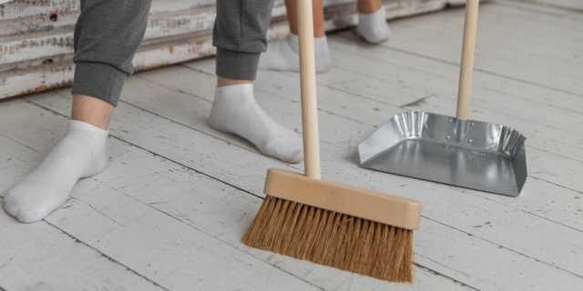 a person sweeping the floor