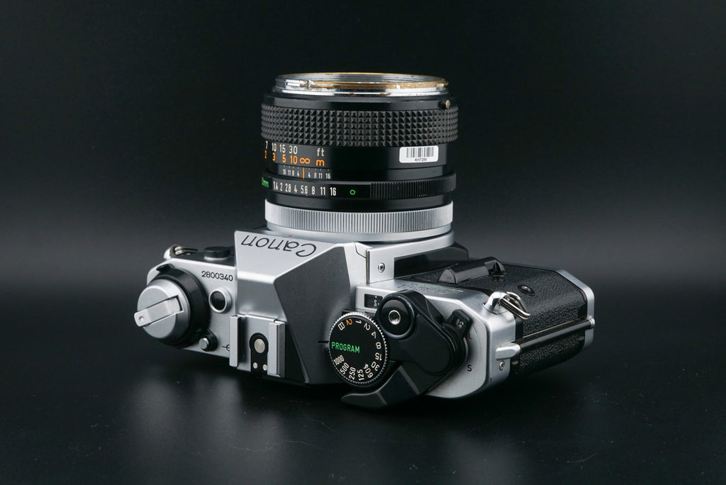 Canon AE-1 Program film camera on a black background