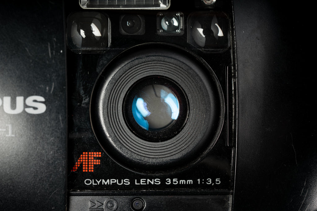 Black Olympus Mju-i close up of the lens