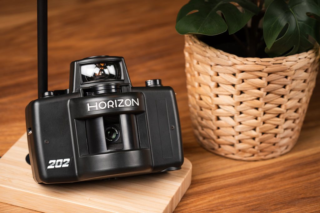 Horizon 202 film camera laying on a nice wooden platform