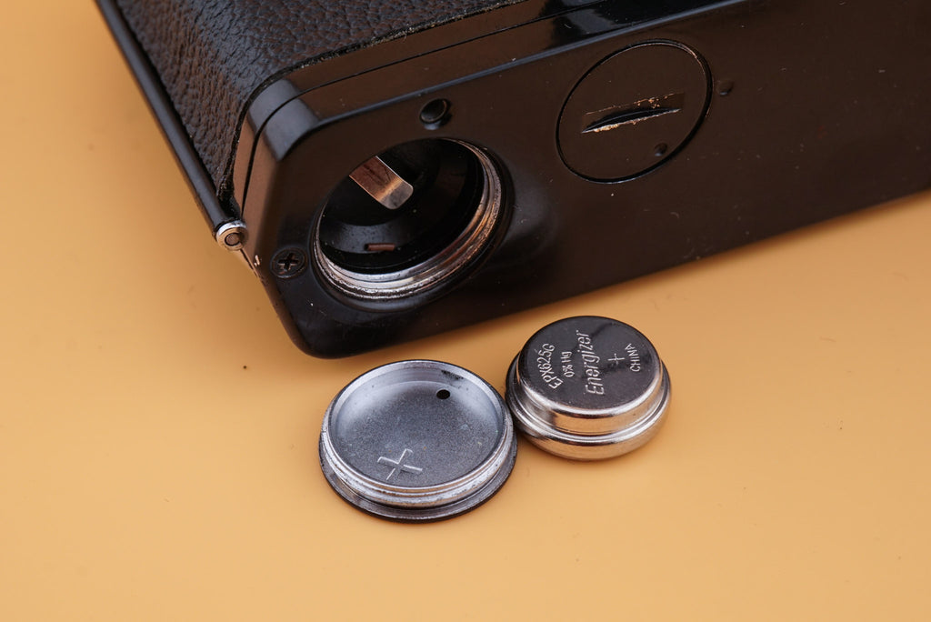 olympus om-1 camera on a table with PX625 battery