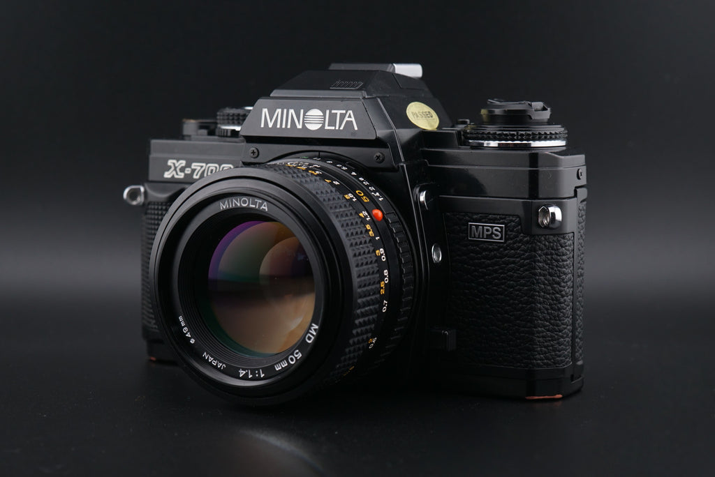 Minolta X-700 film camera on a black background