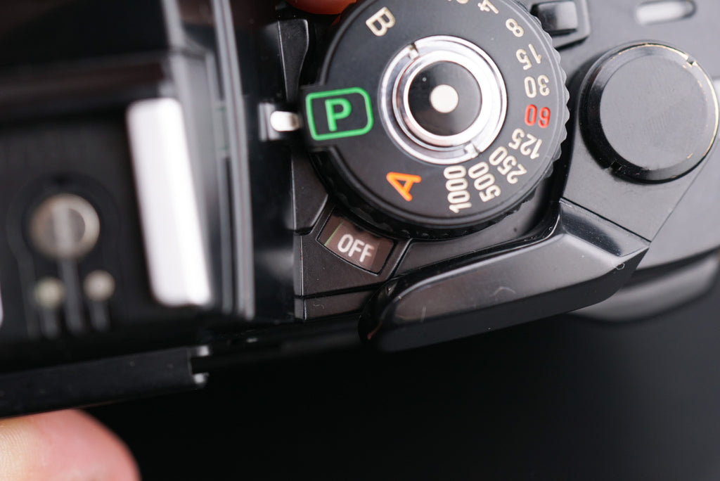 close-up of Minolta X-700 film camera shutter speed dial with text "off"