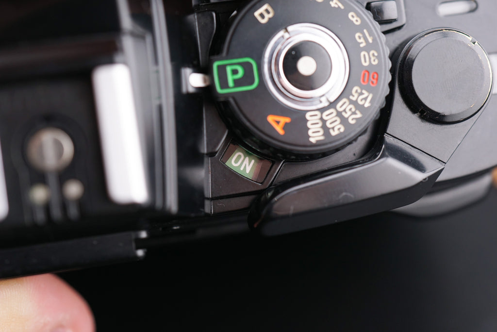 close-up of Minolta X-700 film camera shutter speed dial with text "on"