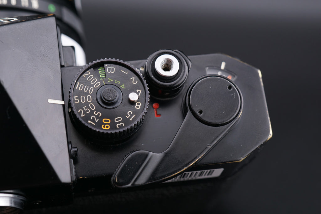 Canon F-1 film camera shutter speed dial, film advance lever, and shutter button