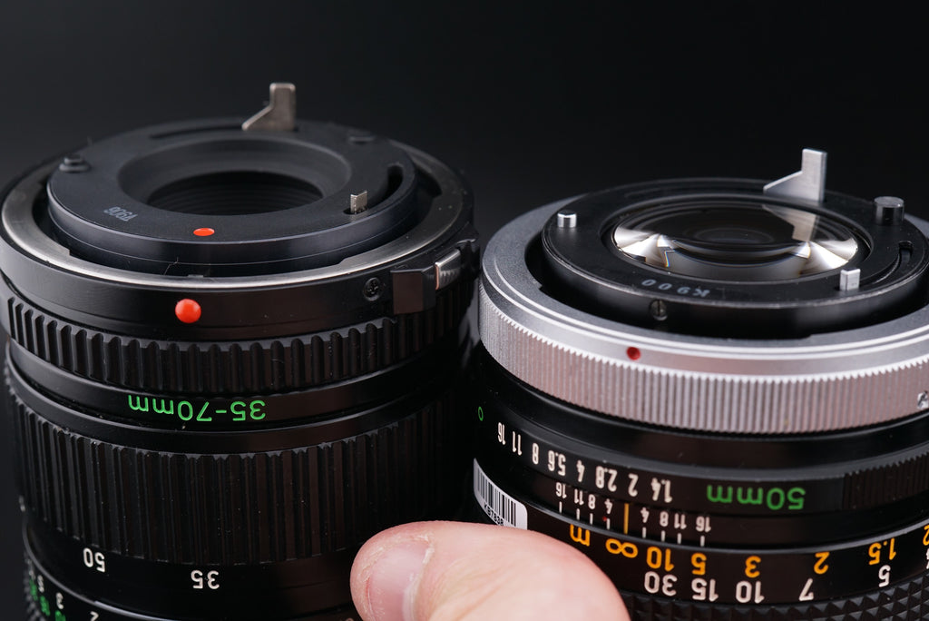 two camera lenses with Canon FD mounts