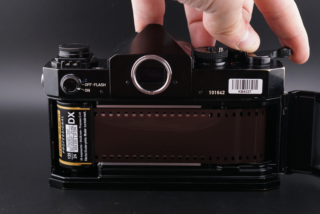 a roll of film inside of a Canon F-1 film camera