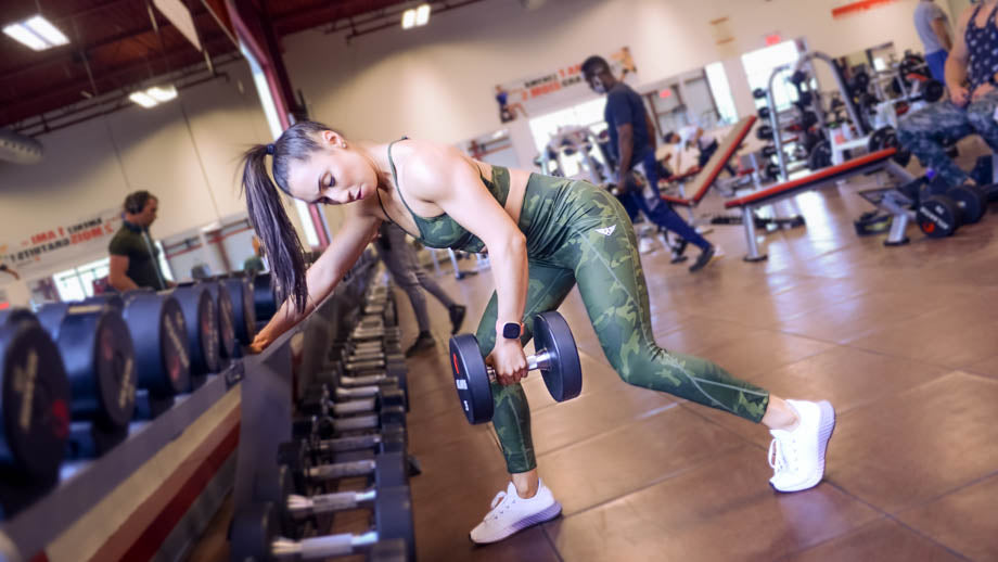 Woman performing bent over rows with a dumbbell