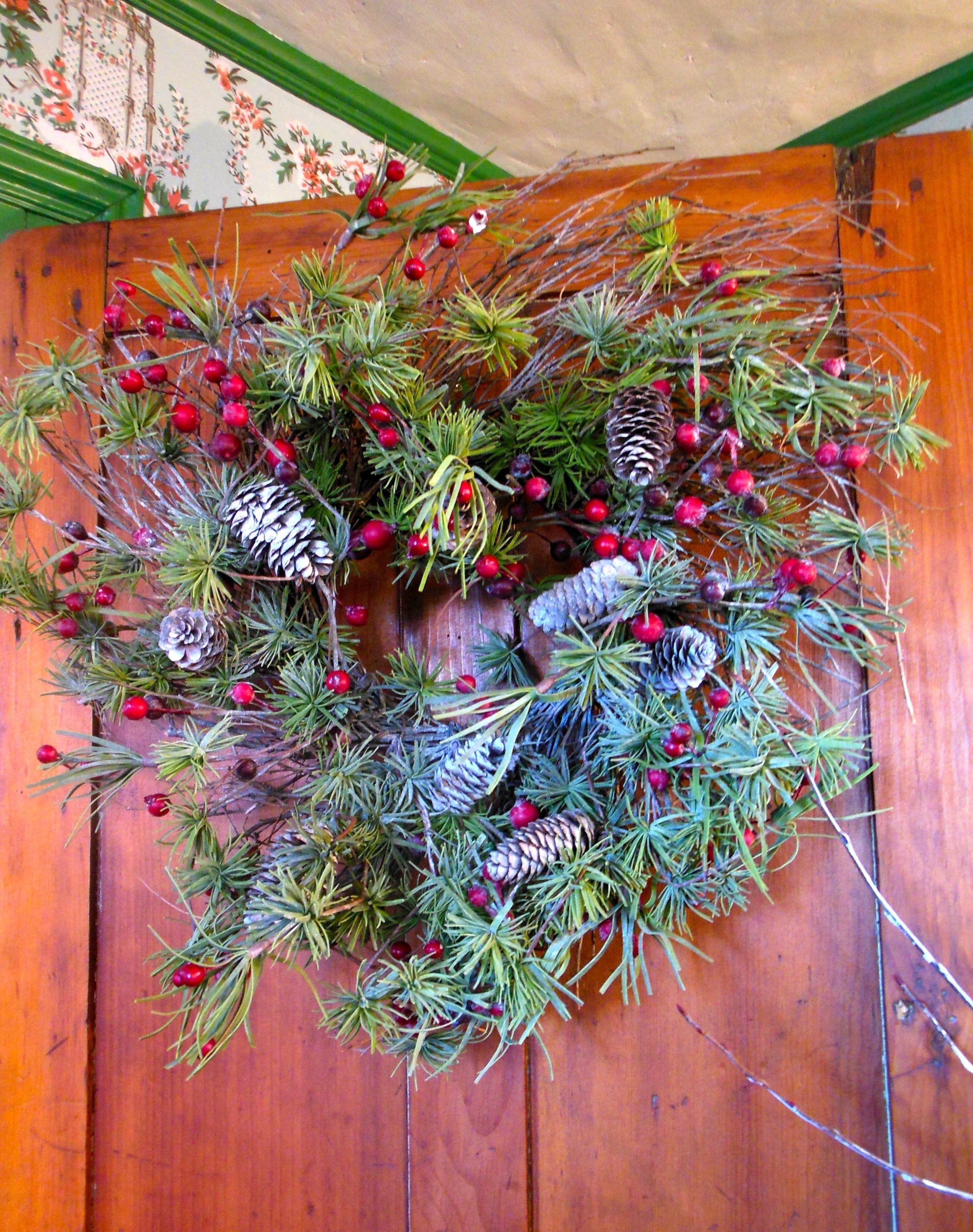 festive wreath hanging on door