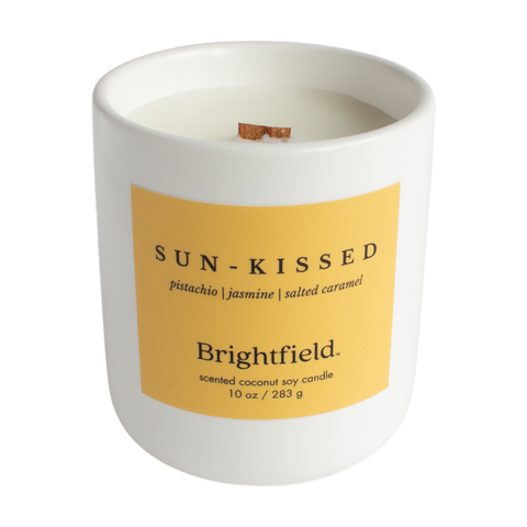 Sun-kissed Tropical Candle from Brightfield, wood wick candle in white ceramic jar with bright yellow label