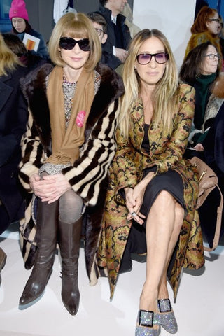 Anna Wintour and Sarah Jessica Parker wearing sunglasses at fashion show