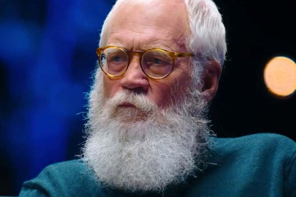 Close-view-of-David-Letterman-looking-serious-during-interview-wearing-round-yellow-eyeglasses-and-blue-jumper