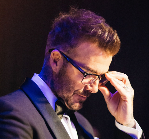 David Beckham presents award at the 2024 BAFTA awards wearing optical glasses from his own brand - Eyewear by David Beckham