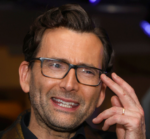 David Tennant wearing Tom Ford glasses at the 2024 BAFTA Awards while he hosts the awards ceremony.