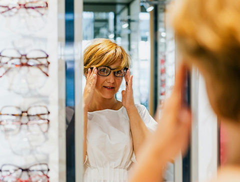 Patient trying on her new prescription glasses after an eye examination