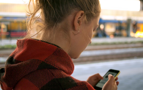 Female with blonde hair looking at mobile phone