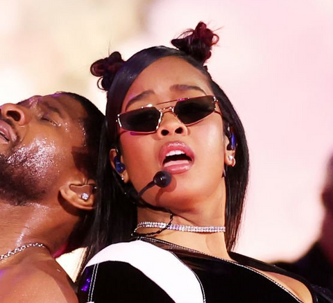 H.E.R. sunglasses at the Super Bowl LVIII 2024 while performing on stage with Usher for the halftime show