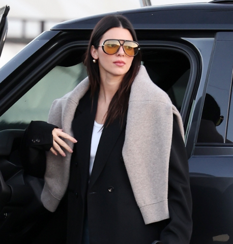 Kendall Jenner wears Bottega Veneta Drop sunglasses with orange tinted lenses