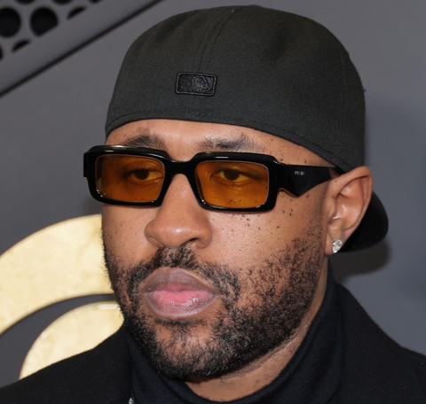 Mike WiLL Made-It on the red carpet the the 66th annual Grammy Awards wearing orange tinted lens sunglasses from Prada