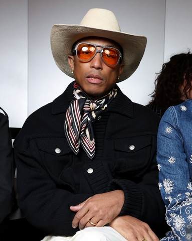 Pharrell Williams wearing red tinted lens sunglasses at the Louis Vuitton FW menswear show - Paris Fashion Week