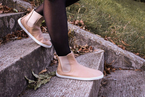 Woman is walking the stairs in barefoot shoes by Ahinsa shoes