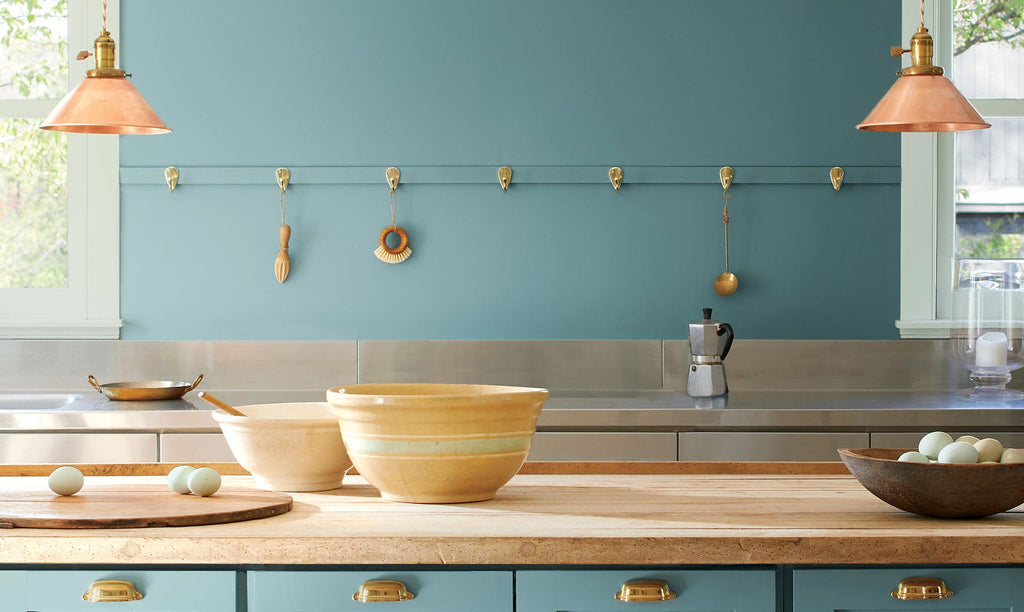 kitchen with blue wall in background and island with bowls in the foreground
