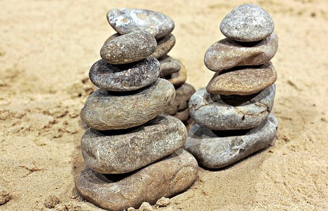 Pile of rocks on ground symbolizing stability.