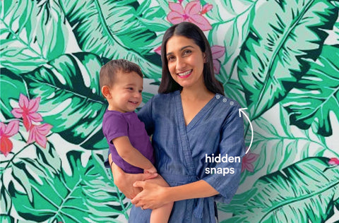 Woman with child in front of green leaf wallpaper